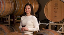 Sharon Fenchak in front of wine barrels