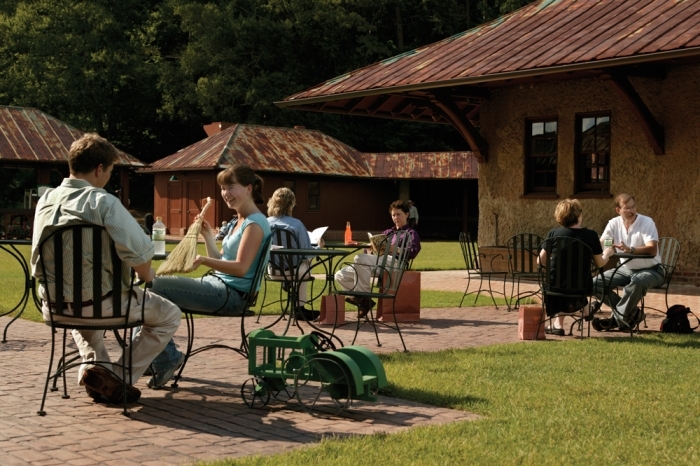 People sitting around tables outside the Antler Hill Barn